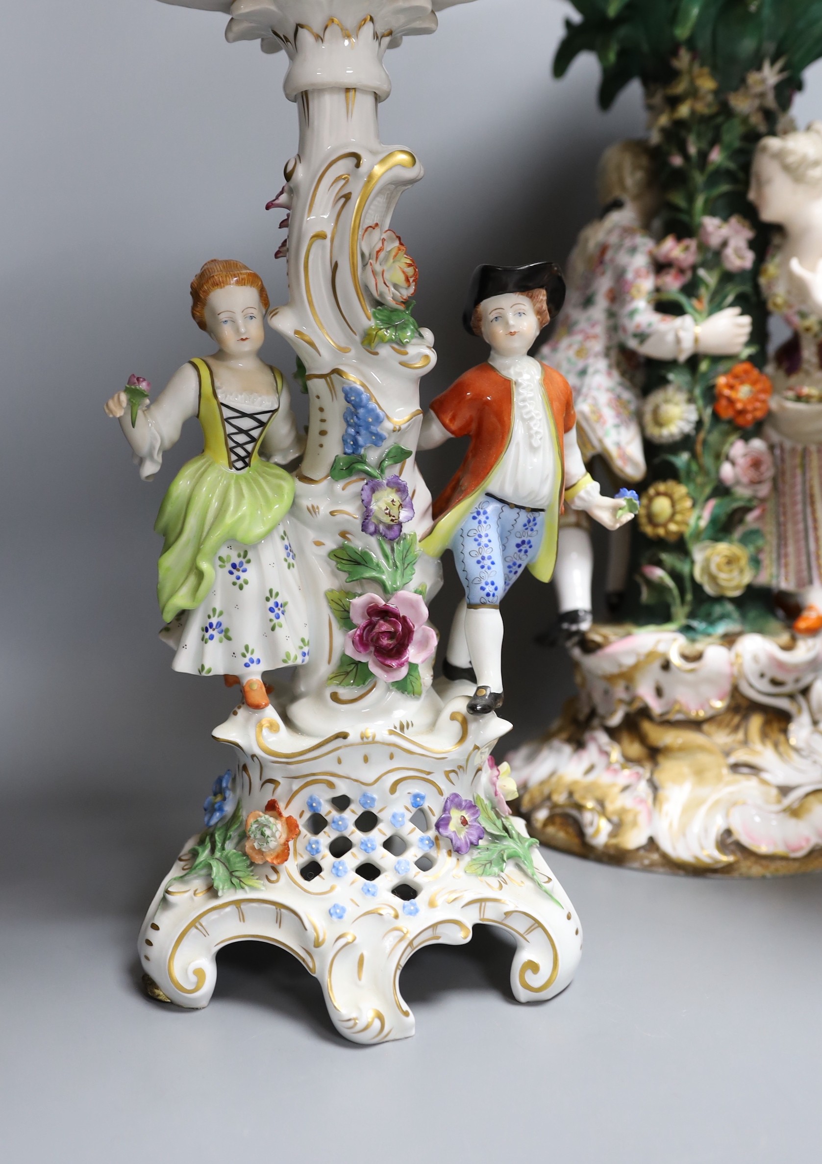 A 19th century Dresden floral encrusted centrepiece and two other continental porcelain centrepieces, tallest 46cm